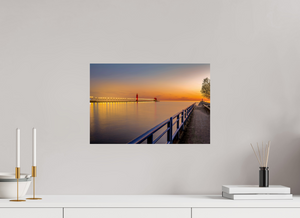 Serene sunset view of the Grand Haven channel, featuring "Calm on the Channel" artwork. Perfect for home decor.