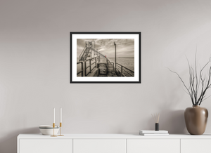 Big Red on the Grand Haven Pier showcases a striking lighthouse amidst a moody black-and-white scene.