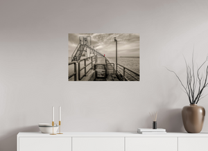 Big Red on the Grand Haven Pier captures a striking lighthouse in vibrant red against a moody black-and-white backdrop.