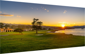 Breathtaking view of No. 18 at Pebble Beach at sunrise, showcasing vibrant greens and tranquil ocean hues.