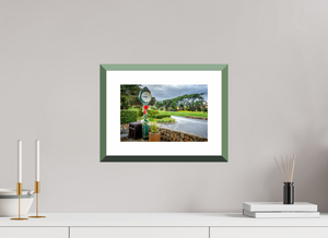 The First Tee at Pebble Beach clock surrounded by lush greenery, capturing the essence of an iconic golf course.