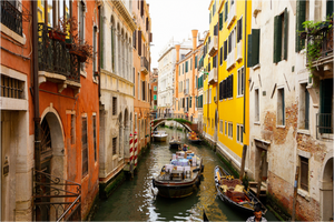 Serene view of a canal in Venice, Italy, showcasing the charm of "Delivery Enroute" deliveries.