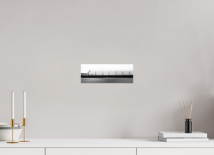 Couple strolls along The Pier in Black and White, with a bird flying and smokestack in the distance.