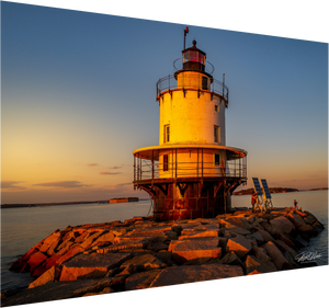 Golden Hour at Spring Point Ledge Lighthouse displays the lighthouse glowing beautifully at sunset in coastal Maine.
