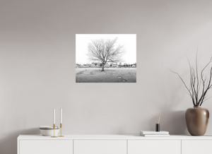 Black-and-white photograph titled "Winter Sentinel of Grand Haven," showcasing serene winter beauty by the coast.