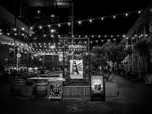 Stunning black and white scene of San Francisco Nights – Ghirardelli Square, showcasing vibrant lights and ambiance.