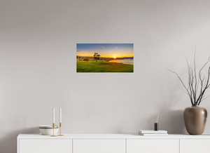 Breathtaking view of No. 18 at Pebble Beach capturing sunrise over the iconic golf course in vibrant colors.