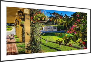 View from Pebble Beach promenade showcasing the Champions of Pebble Beach monument and vibrant flowers nearby.