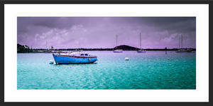 Boats are moored in a serene Caribbean harbor in the vibrant Aftermath in the Harbor artwork.